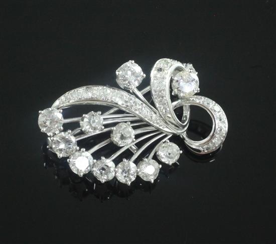 A white gold and diamond set scrolling spray brooch, 30mm.